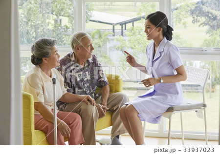A senior couple is sitting and listening what the nurse is saying A senior couple is sitting and listening what the nurse is saying 33937023