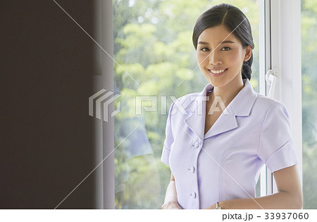 A beautiful nurse in white blouse is smiling A beautiful nurse in white blouse is smiling 33937060