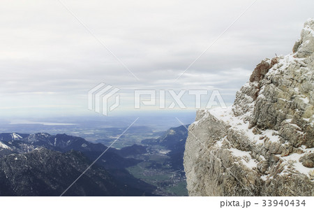 View of a mountain range with snow and clouds 33940434