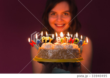 Portrait of pretty girl holding birthday cake 33940495
