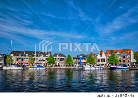 Boats and houses on Spaarne river. Haarlem 33940748
