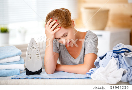 tired woman housewife ironing clothes iron in laundry tired woman housewife ironing clothes iron in laundry 33942236