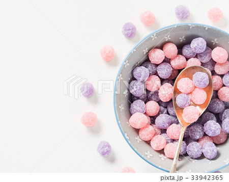 Purple and pink candies in bowl 33942365