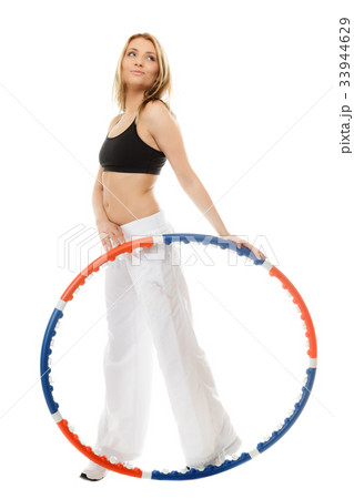 sporty fit girl doing exercise with hula hoop. sporty fit girl doing exercise with hula hoop. 33944629