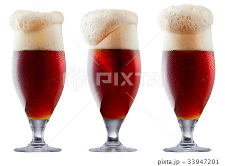Mug of frosty dark red beer with foam 33947201