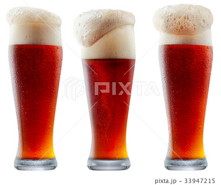 Mug of frosty dark red beer with foam 33947215