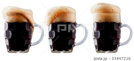 Mug of frosty dark beer with foam Mug of frosty dark beer with foam 33947216