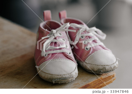Old baby sneakers closeup photo. 33947846