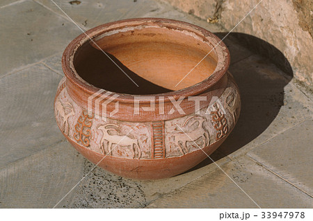 Big clay jug on the street. 33947978