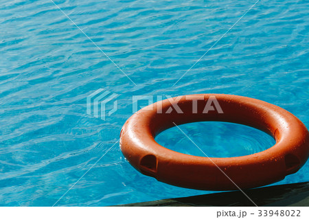 Orange lifebuoy in the blue water. Orange lifebuoy in the blue water. 33948022