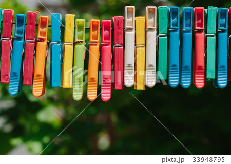 Colorful group of clothespins on a rope. 33948795