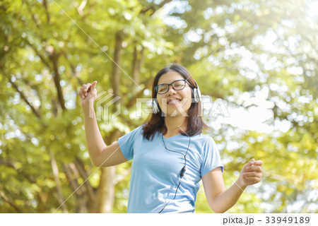 Asian woman listening to the music. 33949189