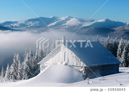 Snowy cabin in the winter mountains 33950045