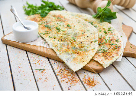 Typical Turkish meal Gozleme with herb and cheese. Typical Turkish meal Gozleme with herb and cheese. 33952344