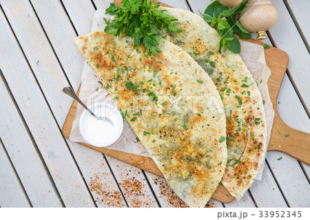 Typical Turkish meal Gozleme with herb and cheese. Typical Turkish meal Gozleme with herb and cheese. 33952345