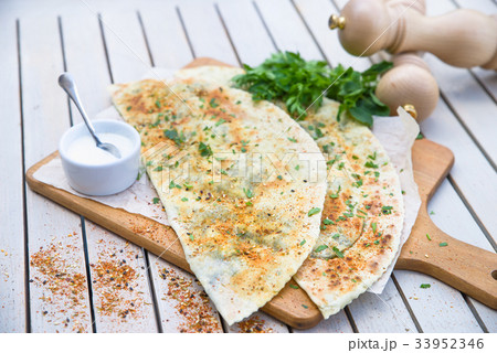Typical Turkish meal Gozleme with herb and cheese. Typical Turkish meal Gozleme with herb and cheese. 33952346