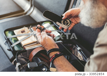Grandfather hand holding compass in airport 33952854