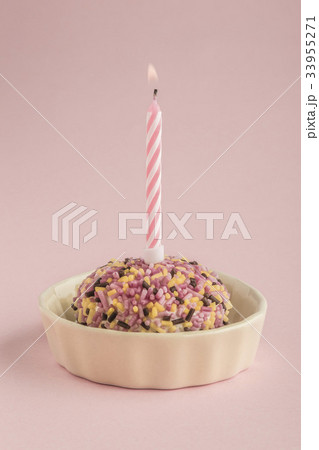 birthday cake with one candle on pink 33955271