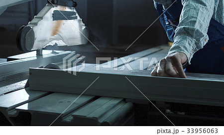 Worker cutting detail in shop 33956063