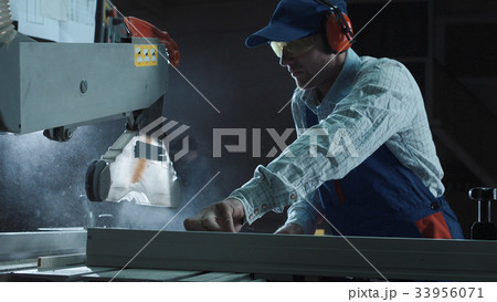 The joiner works on a sawing machine The joiner works on a sawing machine 33956071