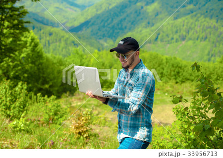 man working on laptop in the fresh air man working on laptop in the fresh air 33956713