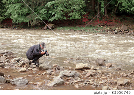 photographer takes pictures of rough river 33956749