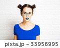 Young Girl with Blue Lips and Two Hair Buns. 33956995