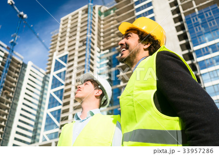 Architects on large construction site giving Architects on large construction site giving 33957286