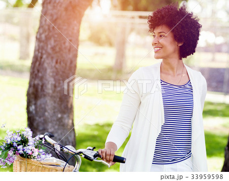 Happy young woman with bicycle Happy young woman with bicycle 33959598
