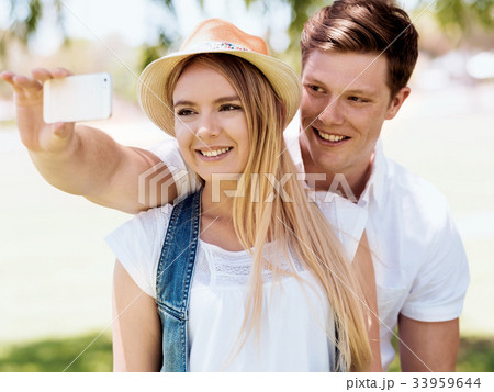 Young couple doing selfie outdoors Young couple doing selfie outdoors 33959644