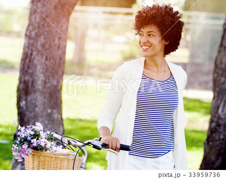 Happy young woman with bicycle 33959736