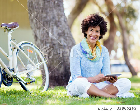 Young woman using tablet in the park. Young woman using tablet in the park. 33960265