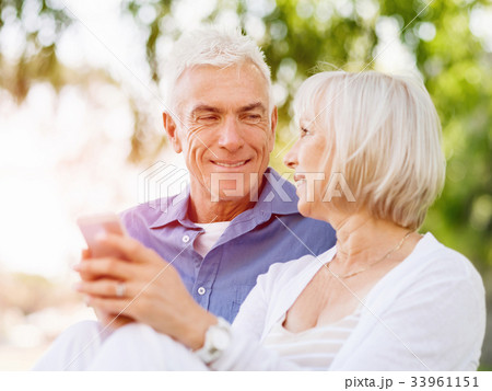 Happy senior couple looking at smartphone Happy senior couple looking at smartphone 33961151