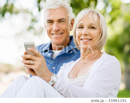 Happy senior couple looking at smartphone Happy senior couple looking at smartphone 33961191