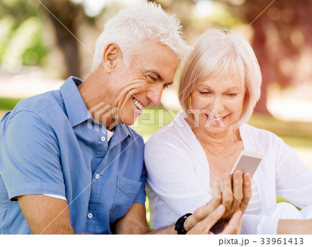 Happy senior couple looking at smartphone 33961413