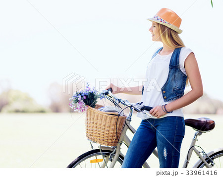 Happy young woman with bicycle Happy young woman with bicycle 33961416