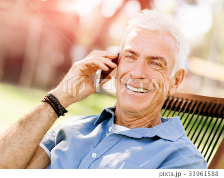 LoMature man outdoors using mobile phone 33961588