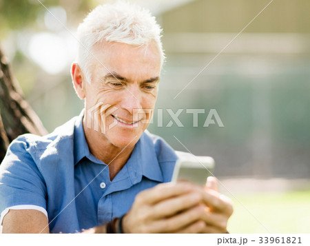 LoMature man outdoors using mobile phone LoMature man outdoors using mobile phone 33961821