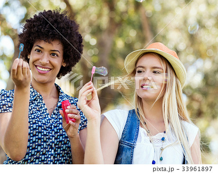 Two women friends in park Two women friends in park 33961897