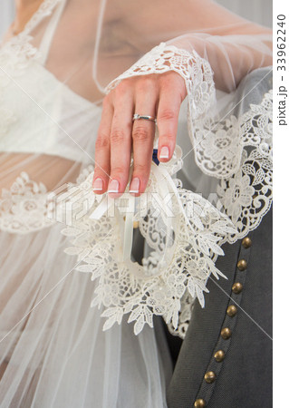 Garter on the leg of a bride, Wedding day moments Garter on the leg of a bride, Wedding day moments 33962240