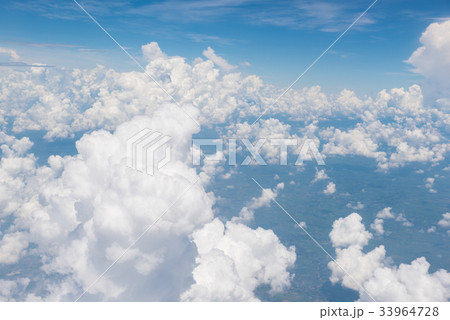 Blue sky and clouds.View from window of airplane. Blue sky and clouds.View from window of airplane. 33964728
