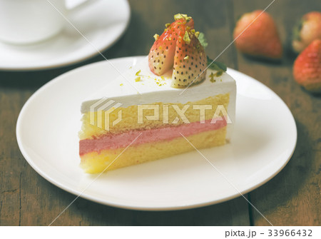 close up of strawberry cream cake on white close up of strawberry cream cake on white 33966432