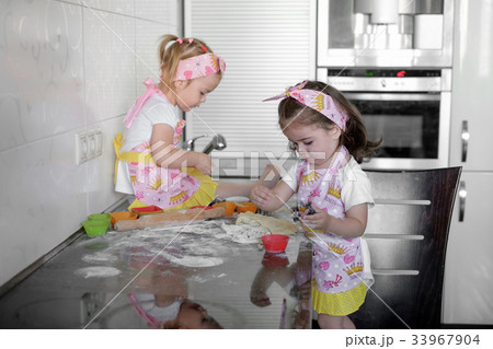 Two happy little girls child cook with flour and Two happy little girls child cook with flour and 33967904