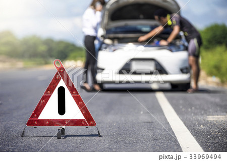 Red emergency stop sign and white car 33969494