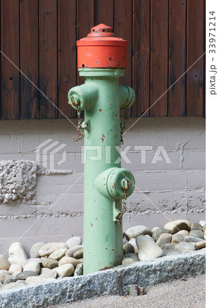 Green fire hydrant on a city sidewalk Green fire hydrant on a city sidewalk 33971214