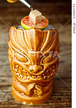Cocktail in a glass of tiki Cocktail in a glass of tiki 33989753