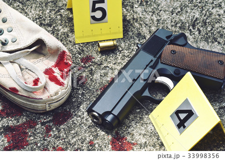 Crime scene investigation, Pistol and bullet shell 33998356