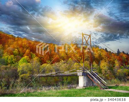 Wooden bridge over mountain river 34043638