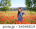 Romantic woman in sundress on poppy field 34046819