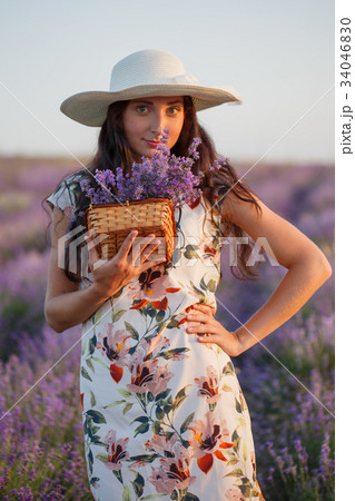 Woman with bunch of lavender in wicker basket 34046830